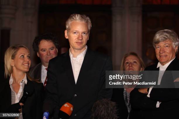 WikiLeaks founder Julian Assange stands with his legal team and speaks to reporters as he leaves The High Court on December 16, 2010 in London,...