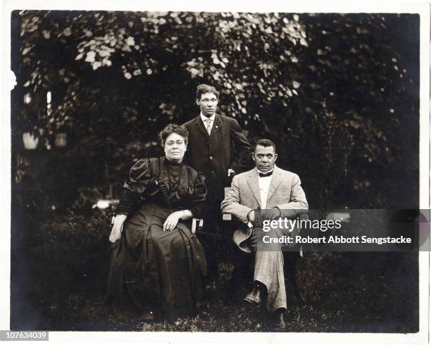 Portrait of married couple Margaret Murray Washington and Booker T Washington , as they pose with their son, Ernest Davidson Washington, outdoors in...