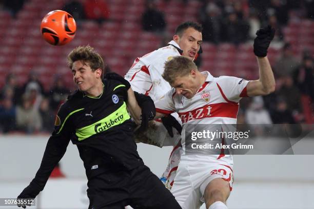 Daniel Hoegh of Odense jumps for a header with Timo Gebhart and Pavel Pogrebnyak of Stuttgart during the UEFA Europa League group H match between VfB...