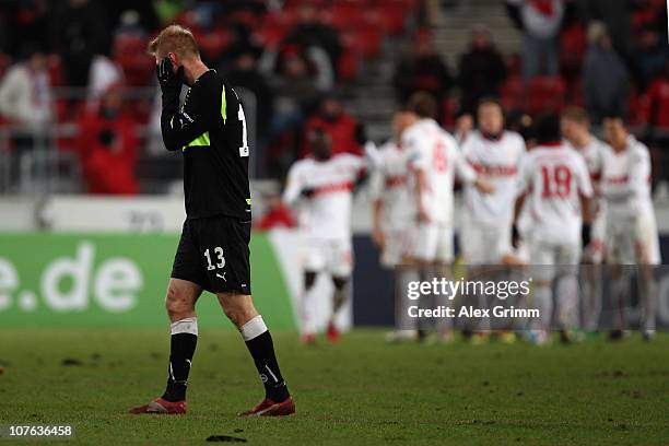 Henrik Toft of Odense reacts as players of Stuttgart celebrates their team's fourth goal during the UEFA Europa League group H match between VfB...