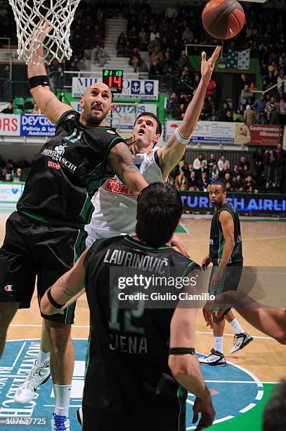 Darjus Lavrinovic, #12 of Fenerbahce Ulker Istanbul competes with Milovan Rakovic, #11 of Montepaschi Siena in action during the 2010-2011 Turkish...