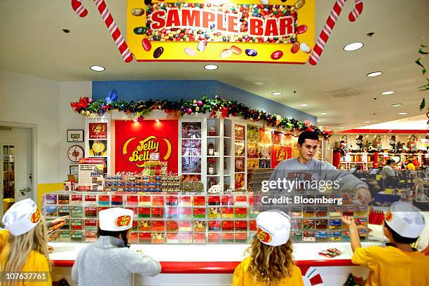 Luis Perez hands outs jelly bean samples to kids at the Jelly Belly Candy Co. Store next to the company's manufacturing facility in Fairfield,...