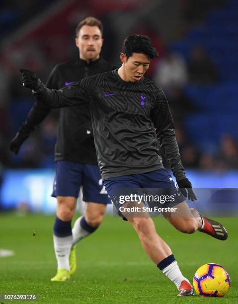 Heung-Min Son of Tottenham Hotspur warms up alongside Christian Eriksen prior to the Premier League match between Cardiff City and Tottenham Hotspur...
