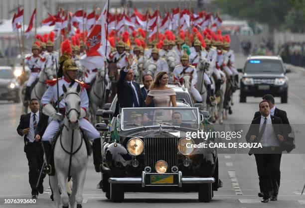 The presidential convoy, led by Brazil's President-elect Jair Bolsonaro and his wife Michelle Bolsonaro in a Rolls Royce, heads to the National...
