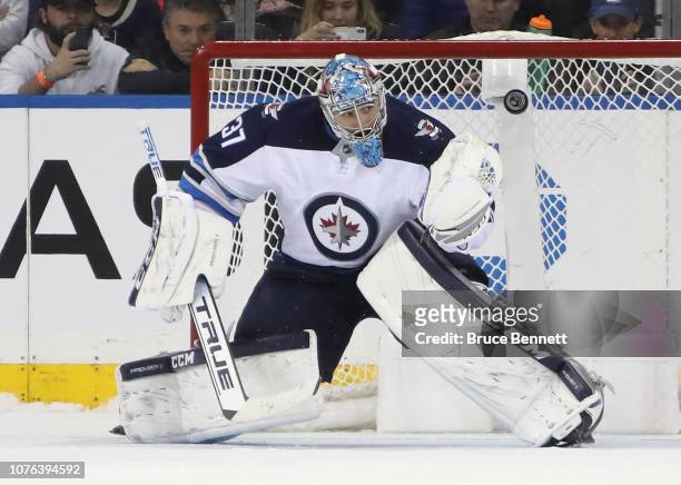 Connor Hellebuyck of the Winnipeg Jets makes the save on Kevin Shattenkirk of the New York Rangers during the shootout skates against the New York...