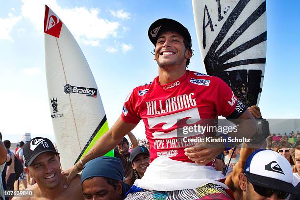 Jeremy Flors of France is chaired up the beach alongside 10X ASP World Champion Kelly Slater of the United States of America after winning the...