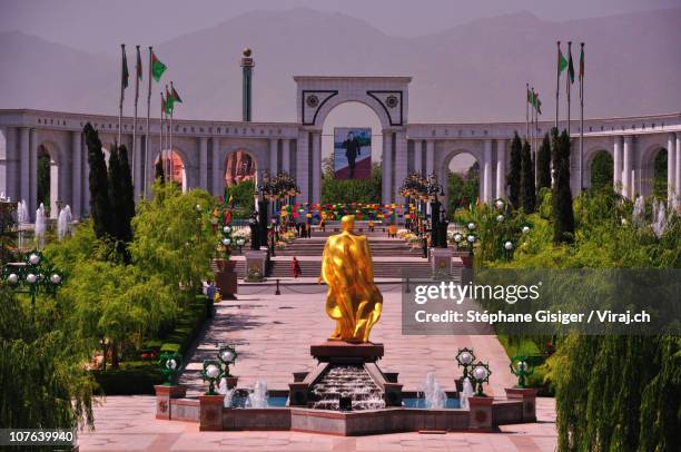 a golden statue in ashgabat - turkmenistan stock pictures, royalty-free photos & images