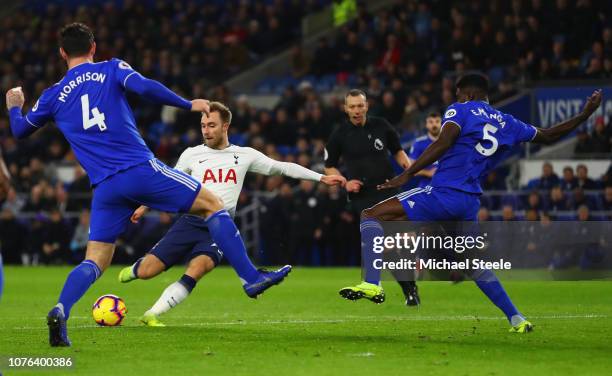Christian Eriksen of Tottenham Hotspur shoots past Sean Morrison and Bruno Ecuele Manga of Cardiff City as he scores his team's second goal during...