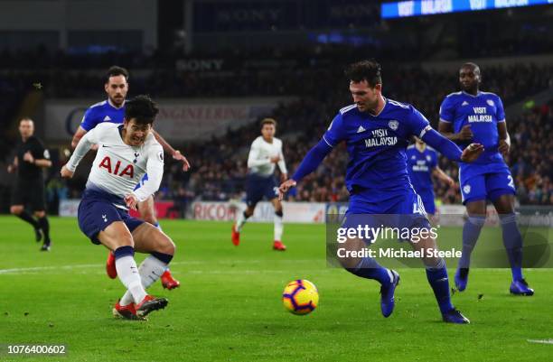 Heung-Min Son of Tottenham Hotspur shoots past Sean Morrison of Cardiff City as he scores his team's third goal during the Premier League match...