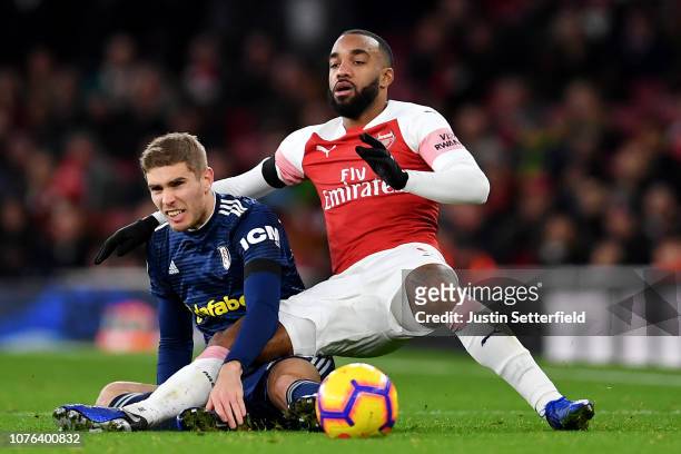Maxime Le Marchand of Fulham tackles Alexandre Lacazette of Arsenal during the Premier League match between Arsenal FC and Fulham FC at Emirates...