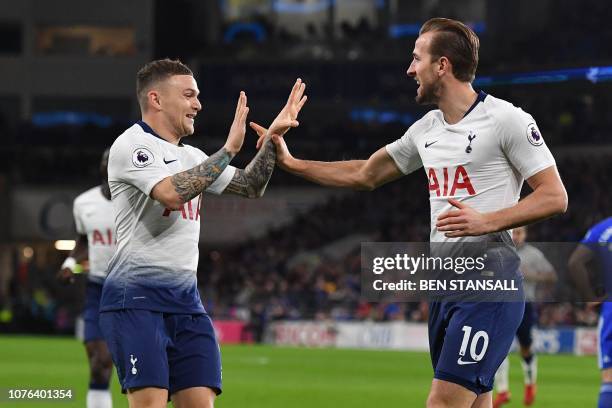 Tottenham Hotspur's English striker Harry Kane celebrates scoring his team's first goal with Tottenham Hotspur's English defender Kieran Trippier...
