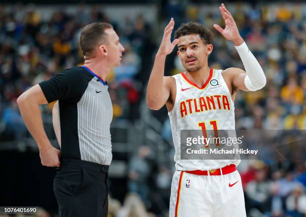 Referee Justin Van Duyne talks with Trae Young of the Atlanta Hawks during the game against the Indiana Pacers at Bankers Life Fieldhouse on December...