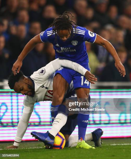 Danny Rose of Tottenham Hotspur tangles with Bobby Reid of Cardiff City during the Premier League match between Cardiff City and Tottenham Hotspur at...