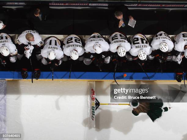 The Anaheim Ducks sit on the bench during a timeout as an ice girls cleans the ice during the game against the New York Islanders at the Nassau...