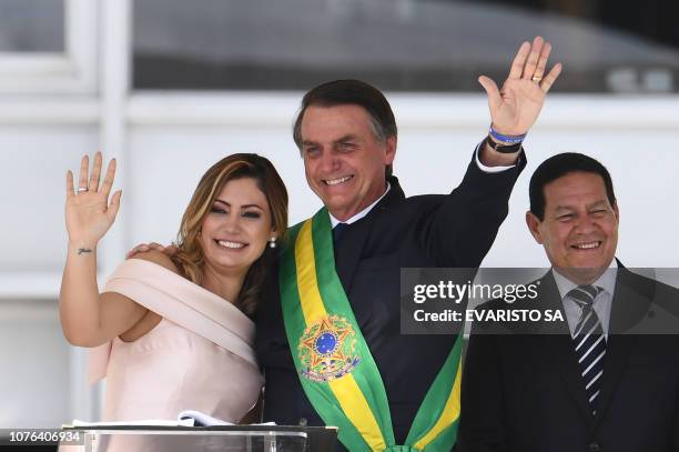 Brazil's new President Jair Bolsonaro and First Lady Michelle Bolsonaro wave to supporters near Brazil's new Vice-President Hamilton Mourao, during...