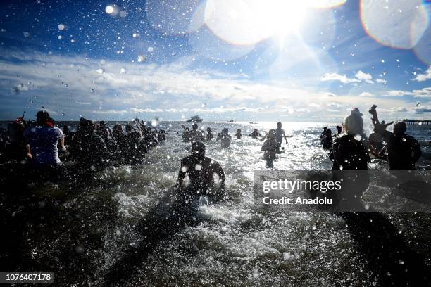 Participants are seen in the water during a polar bear plunge at the beach in Coney Island in New York, United States on January 01, 2019.