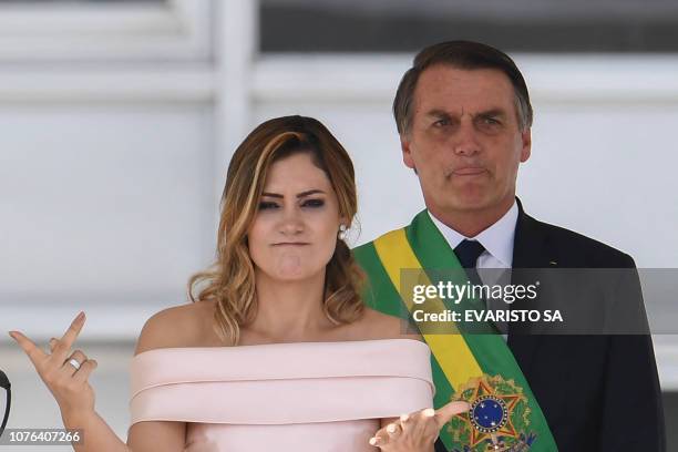 Brazil's new First Lady Michelle Bolsonaro delivers a speech in sign language flanked by his husband Brazil's new president Jair Bolsonaro, at...