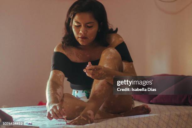 woman painting her toenails - painting toenails stock-fotos und bilder