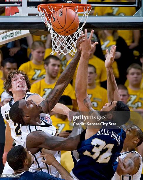 Missouri's Ricardo Ratliffe, middle, battles for a rebound against Oral Roberts' Damen Bell-Holter at Mizzou Arena, in Columbia, Missouri, on...