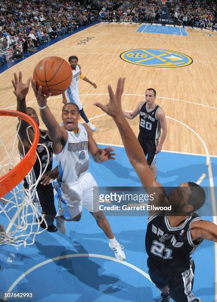 Aaron Afflalo of the Denver Nuggets goes to the basket against Tim Duncan of the San Antonio Spurs on December 16, 2010 at the Pepsi Center in...