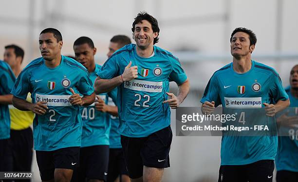 Ivan Cordoba, Diego Milito and Javier Zanetti warm up during the FC Internazionale Milano Training Session at the Armed Forces Stadium on December...