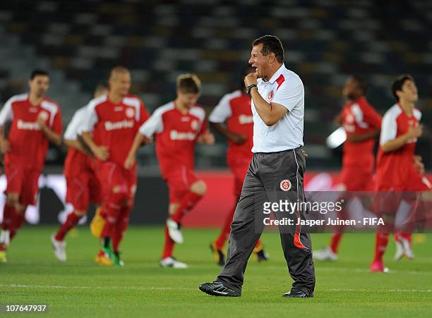 Head coach Celso Roth of Sport Club Internacional walks past his players during a training session at Zayed Sports City on December 17, 2010 in Abu...