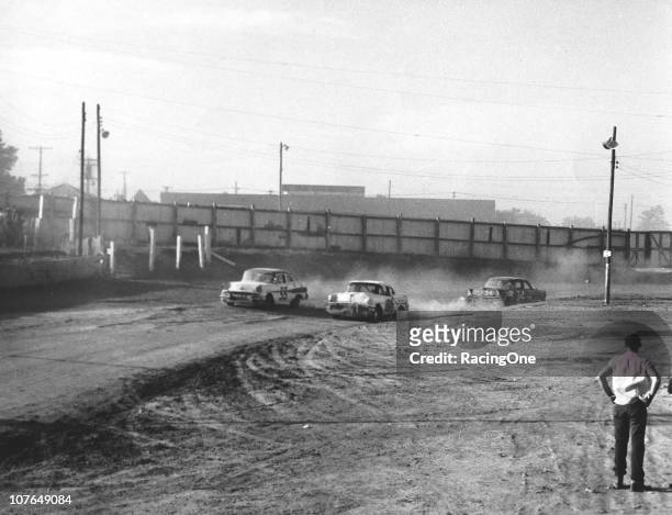 Ralph Earnhardt , driving a Petty Enterprises Oldsmobile, battles side-by-side with Tiny LundÕs Pontiac during a NASCAR Cup race at the Greensboro...