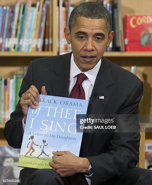 President Barack Obama reads his children's book, "Of Thee I Sing: A Letter to My Daughters," to students at Long Branch Elementary School in...