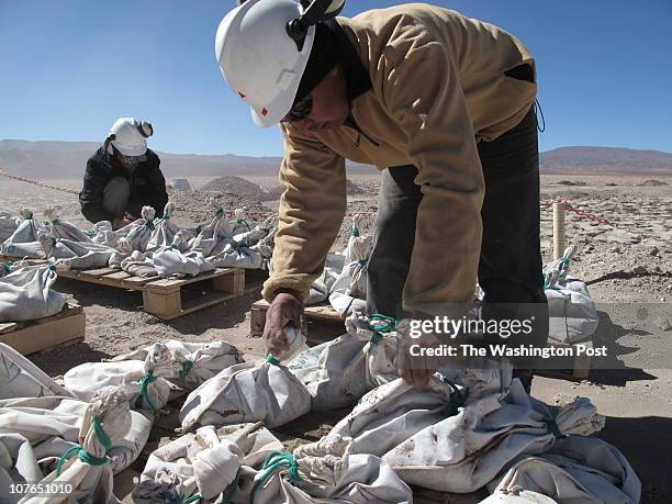 Workers for Exar, the Argentine affiliate of Lithium Americas Corp., bag and tag brine extracted from an exploratory well. The muck will be tested to...