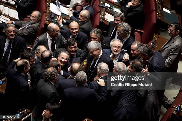 Italian Prime Minister Silvio Berlusconi shares a joke with his political opponent Pier Ferdinando Casini, during a session on the confidence vote to...