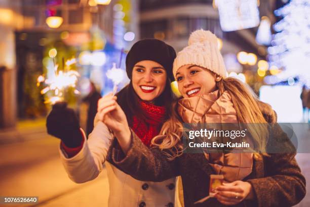friends are enjoying the christmas eve - street party stock pictures, royalty-free photos & images