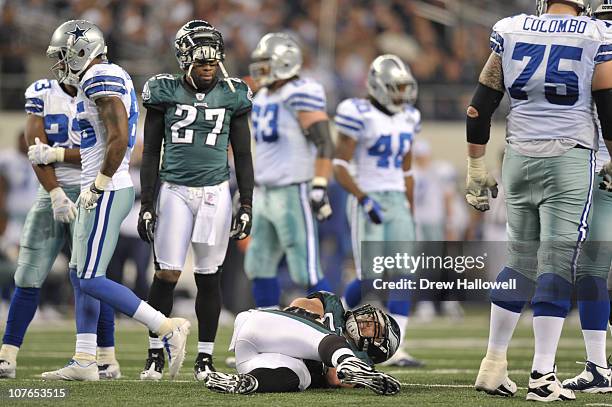 Injured linebacker Stewart Bradley of the Philadelphia Eagles is watched over by teammate safety Quintin Mikell during the game against the Dallas...