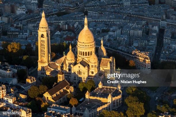 aerial flying over the sacré-cœur in paris france, sunset - basílica del sagrado corazón de montmartre fotografías e imágenes de stock
