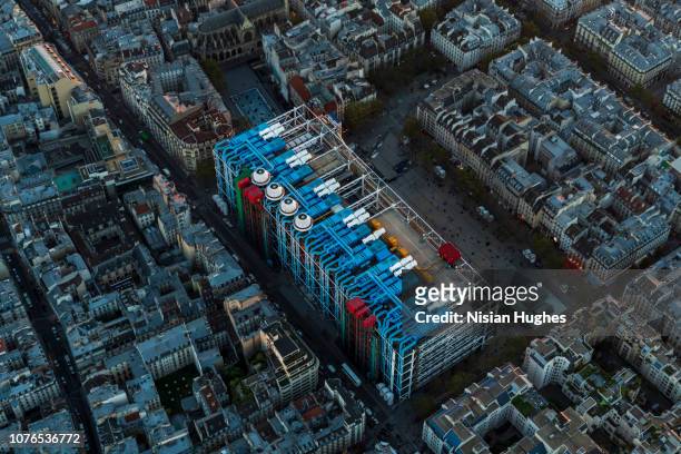 aerial flying over paris france with view of le centre pompidou at sunset - louvre stock-fotos und bilder