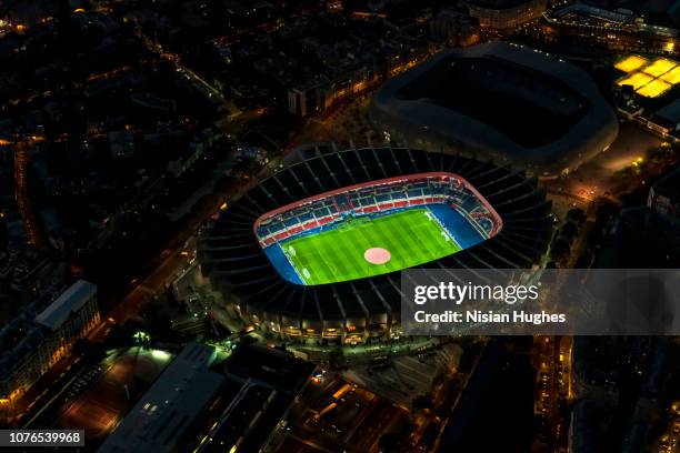 aerial flying over soccer stadium with lights on in paris france - football stadium night stock pictures, royalty-free photos & images