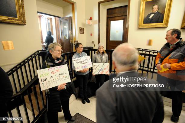 Anti-gun lobbyist greet lawmakers in the state house during the opening day of the House of Representatives at the New Hampshire State House, where...