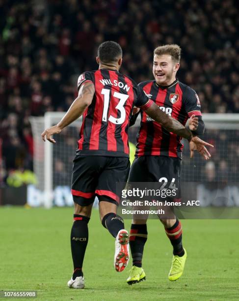 Ryan Fraser congratulates team-mate Callum Wilson of Bournemouth after he scores a goal to make it 2-2 during the Premier League match between AFC...