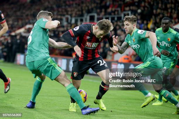 Miguel Angel Britos and Ken Sema of Watford stop Ryan Fraser of Bournemouth during the Premier League match between AFC Bournemouth and Watford FC at...