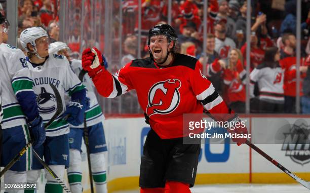Sami Vatanen of the New Jersey Devils celebrates his third period goal against the Vancouver Canucks with his teammates at Prudential Center on...