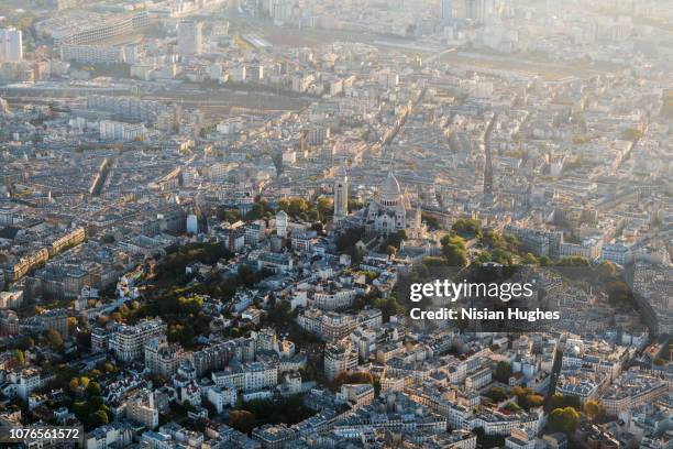 aerial flying over the sacré-cœur in paris france, sunrise - map paris photos et images de collection