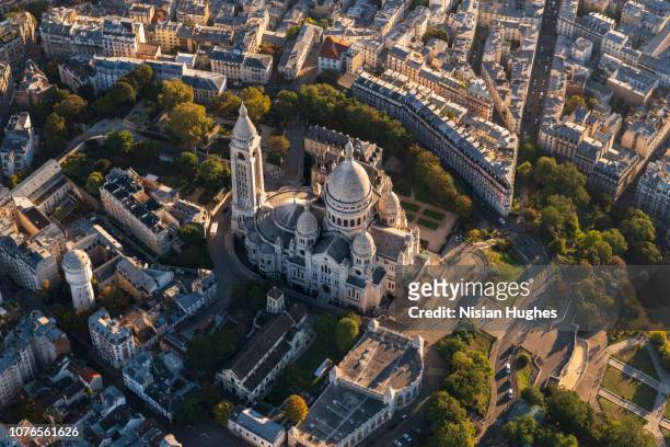 aerial flying over the sacré-cœur in paris france, sunrise - basilique du sacre coeur montmartre stock pictures, royalty-free photos & images