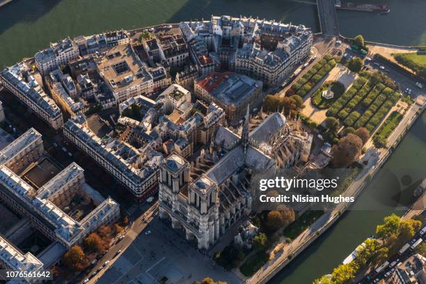 aerial flying over cathédrale notre-dame de paris in paris france - ile-de-la-cite stock pictures, royalty-free photos & images