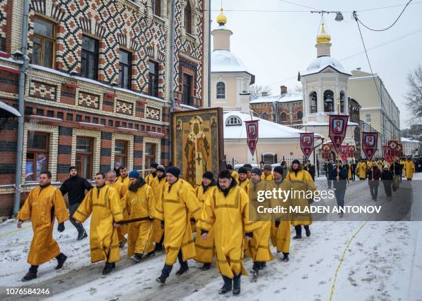 Russian Orthodox priests walk during a religious procession celebrating Saint Peter of Kiev, Metropolitan of Kiev and Moscow, at the Vissoko...