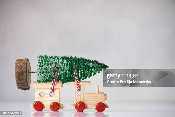 christmas tree on the top of a wooden toy train - miniature train stock pictures, royalty-free photos & images