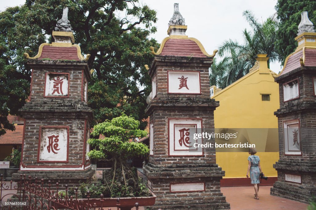 Rear View Full Length Of Woman Walking Outside Temple