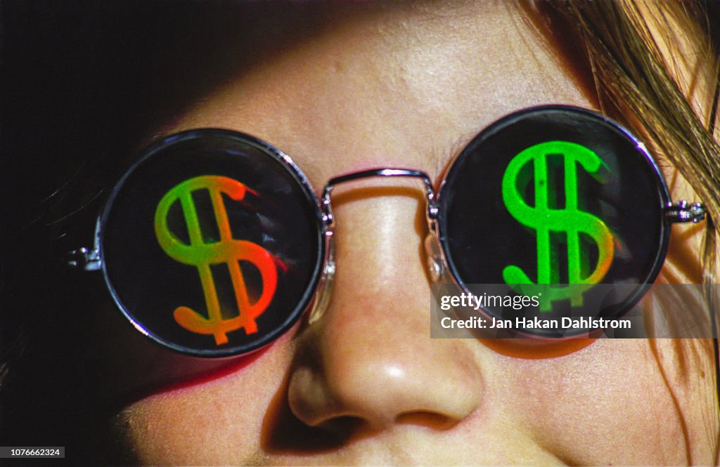 Girl wearing dollaar sign sunglasses