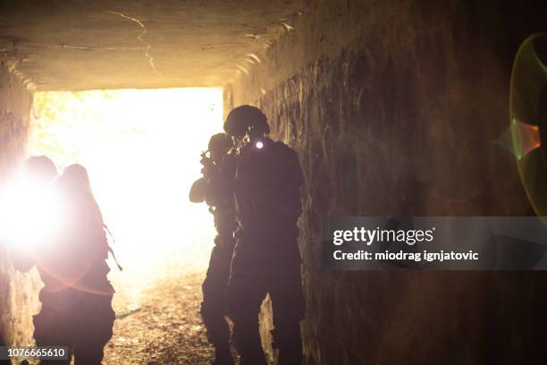 licht aan het eind van de tunnel - mercenary human role stockfoto's en -beelden