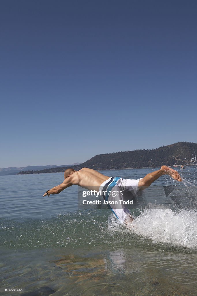 Man diving into lake water