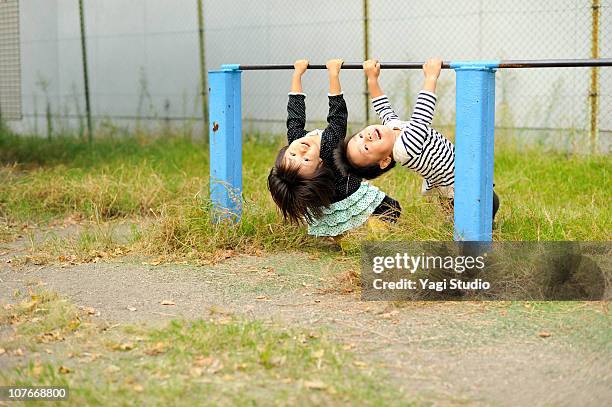 the boy playing a horizontal bar, and girl - horizontal bars stock pictures, royalty-free photos & images