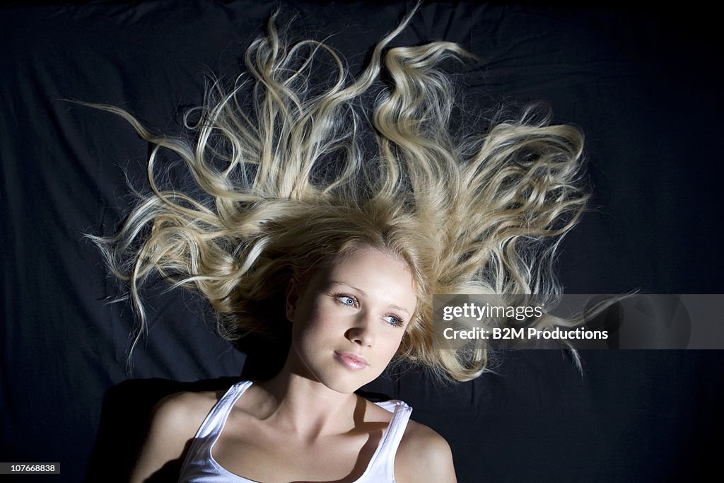 Portrait of a woman lying on bed